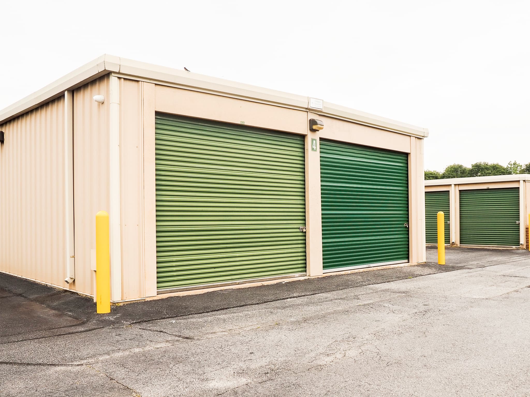 Large storage units with green roll-up doors